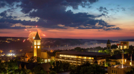 Cornell clock tower image with fireworks at sunset