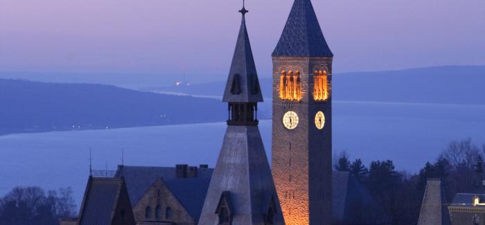 Cornell clock tower at sunset with lake in background